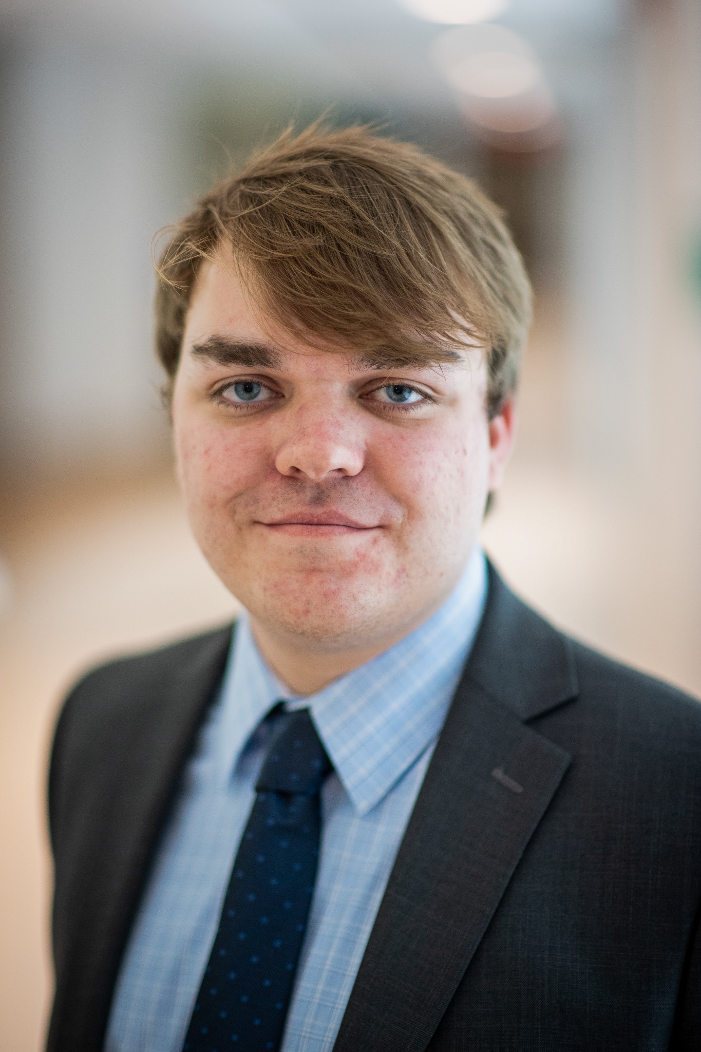 Headshot of Will McCumber in suit and tie